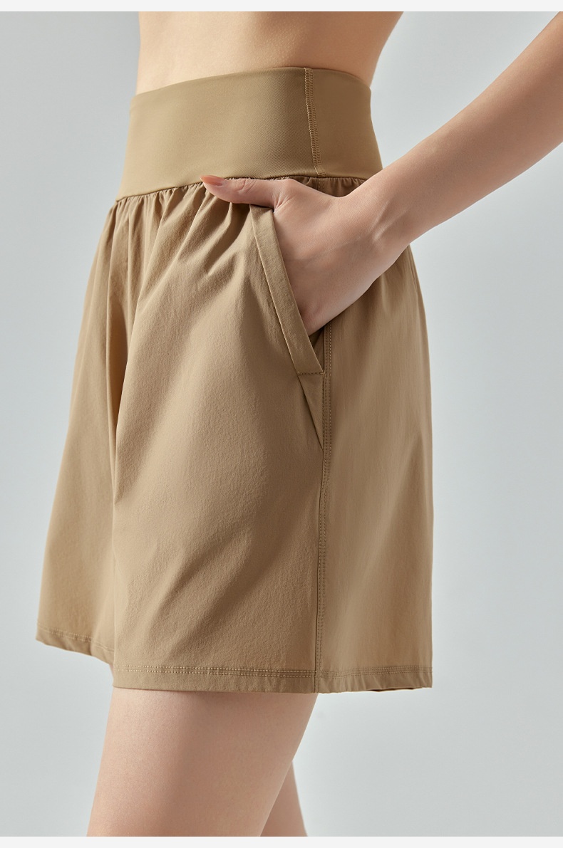 Letnie, proste, sportowe spodnie damskie, pięciopunktowe, luźne, oddychające, z wysokim stanem i kieszenią boczną wyszczuplającą brzuch_voghion.com